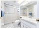 Clean bathroom equipped with a glass-enclosed shower and white tiled floors at 11996 117Th St, Seminole, FL 33778
