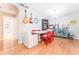 A well-lit dining room featuring a table set for four, hardwood floors and a decorative credenza for storage at 11996 117Th St, Seminole, FL 33778