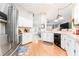 Bright kitchen with white cabinets, stainless steel appliances, and hardwood flooring at 11996 117Th St, Seminole, FL 33778
