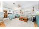 Cozy living room features two recliner chairs, a sofa, and a decorative ceiling fan at 11996 117Th St, Seminole, FL 33778