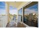 Private balcony with comfortable seating offering panoramic ocean and garden views at 12000 Gulf Blvd # 506N, Treasure Island, FL 33706