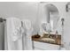 Well-lit bathroom featuring a granite countertop, oval mirror, and decorative towels at 12000 Gulf Blvd # 506N, Treasure Island, FL 33706