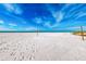 White sand beach with a volleyball net and blue skies at 12000 Gulf Blvd # 506N, Treasure Island, FL 33706
