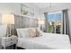 Well-lit bedroom with cozy furnishings and a beach view at 12000 Gulf Blvd # 506N, Treasure Island, FL 33706