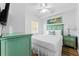 Cozy bedroom with green furniture, a queen bed, a ceiling fan, and a landscape painting at 12000 Gulf Blvd # 506N, Treasure Island, FL 33706