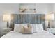 Comfortable bedroom featuring a decorative headboard and beach artwork at 12000 Gulf Blvd # 506N, Treasure Island, FL 33706