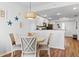 Cozy dining area with white walls, beachy décor, and a partial view of the modern kitchen at 12000 Gulf Blvd # 506N, Treasure Island, FL 33706