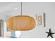 Pendant lighting illuminates the dining area with white walls and beachy decorations at 12000 Gulf Blvd # 506N, Treasure Island, FL 33706