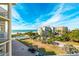 Building exterior with a pool and beach view, palm trees, and blue skies at 12000 Gulf Blvd # 506N, Treasure Island, FL 33706