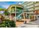 Multi-level deck with outdoor seating and vibrant tropical foliage at 12000 Gulf Blvd # 506N, Treasure Island, FL 33706