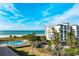 Building exterior with views of the beach and ocean with palm trees at 12000 Gulf Blvd # 506N, Treasure Island, FL 33706