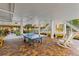 Game area with a ping pong table, white rocking chairs and brick pavers at 12000 Gulf Blvd # 506N, Treasure Island, FL 33706