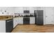 Modern kitchen featuring white cabinets, granite countertops, and sleek black appliances for a contemporary aesthetic at 12000 Gulf Blvd # 506N, Treasure Island, FL 33706