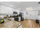 Open kitchen view with granite counters, black appliances, and white cabinetry creates a welcoming and functional space at 12000 Gulf Blvd # 506N, Treasure Island, FL 33706