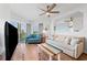 Bright and airy living room featuring wood floors and coastal-themed décor with balcony access at 12000 Gulf Blvd # 506N, Treasure Island, FL 33706