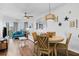 Bright and airy living room featuring wood floors and coastal-themed décor with balcony access at 12000 Gulf Blvd # 506N, Treasure Island, FL 33706