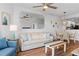 Inviting living room with wood floors, a large mirror, and cozy decor, creating a relaxing space at 12000 Gulf Blvd # 506N, Treasure Island, FL 33706