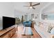 Bright and airy living room featuring wood floors and coastal-themed décor with balcony access at 12000 Gulf Blvd # 506N, Treasure Island, FL 33706
