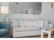 Bright living room features neutral sofa with decorative pillows and unique side table at 12000 Gulf Blvd # 506N, Treasure Island, FL 33706