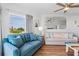 Bright living room features a large window, a ceiling fan, and comfortable sofas and decor at 12000 Gulf Blvd # 506N, Treasure Island, FL 33706
