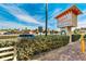 Sign for beachfront suites, surrounded by well-maintained landscaping at 12000 Gulf Blvd # 506N, Treasure Island, FL 33706