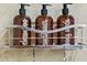 Shower featuring shampoo, conditioner, and body wash dispensers mounted on a metal rack at 12000 Gulf Blvd # 506N, Treasure Island, FL 33706