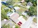 Aerial view of a home with a pool, shed, boat, two red cars, driveway and the street in front at 12037 1/2 Murray Ave, Seminole, FL 33778