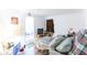 Bedroom space with a bed and pillows, features a door leading to the outside at 12037 1/2 Murray Ave, Seminole, FL 33778