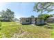 Rear angle of the home, exhibiting backyard, and additional exterior at 12037 1/2 Murray Ave, Seminole, FL 33778