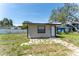Exterior angle of home with new paint, landscaping, and driveway at 12037 1/2 Murray Ave, Seminole, FL 33778