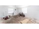Empty room with plywood flooring, windows, and a bicycle at 12037 1/2 Murray Ave, Seminole, FL 33778