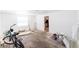 Room featuring plywood flooring, windows, a door and a bicycle at 12037 1/2 Murray Ave, Seminole, FL 33778