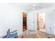 Room with a doorframe to a bathroom with tile flooring and the room has plywood floors at 12037 1/2 Murray Ave, Seminole, FL 33778
