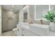 This bathroom features double sinks, modern lighting, and a glass-enclosed shower at 12092 97Th Ave, Seminole, FL 33772