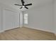A bedroom features a closet, a modern ceiling fan, wood-look floors, and a window at 12092 97Th Ave, Seminole, FL 33772