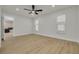 A bedroom features two windows, a modern ceiling fan and wood-look floors at 12092 97Th Ave, Seminole, FL 33772