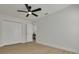 Bright bedroom features a ceiling fan, closet, and wood-look flooring at 12092 97Th Ave, Seminole, FL 33772