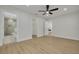 A bedroom features three doorways and wood-look floors at 12092 97Th Ave, Seminole, FL 33772