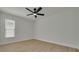 A bedroom features a modern ceiling fan, wood-look floors, and a window at 12092 97Th Ave, Seminole, FL 33772