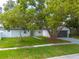Charming home with a well-manicured lawn, mature trees, and a two-car garage at 12092 97Th Ave, Seminole, FL 33772