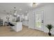 Open-concept kitchen with a breakfast bar, white cabinets, stainless steel appliances, and modern pendant lighting at 12092 97Th Ave, Seminole, FL 33772