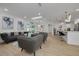 Bright living room featuring modern gray furniture, light wood floors, skylight, and sliding glass doors to lanai at 12092 97Th Ave, Seminole, FL 33772