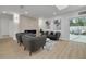 Bright living room with a modern fireplace, cozy seating, light wood floors, art, and access to an outdoor space at 12092 97Th Ave, Seminole, FL 33772