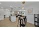 Open concept living and kitchen area featuring modern lighting, island with cooktop and barstool seating at 12092 97Th Ave, Seminole, FL 33772