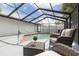 Relaxing screened-in pool area with comfortable seating and a serene atmosphere at 12092 97Th Ave, Seminole, FL 33772