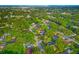Neighborhood aerial shot with lush trees and a pin highlighting the location at 1242 Whisper Dr, Largo, FL 33770