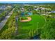 Aerial view of a well-maintained baseball field and tennis court with nearby amenities at 1242 Whisper Dr, Largo, FL 33770