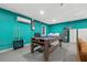 Finished basement with a pool table, turquoise walls, and a set of pool sticks at 1242 Whisper Dr, Largo, FL 33770