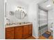 Bathroom featuring a stylish sink, round mirror, and a shower with a striped curtain at 1242 Whisper Dr, Largo, FL 33770