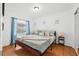 Cozy bedroom with hardwood floors, soft blue accents, and a large closet with sliding mirror doors at 1242 Whisper Dr, Largo, FL 33770